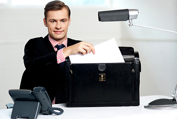 Image showing Male executive keeping documents safely