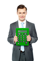 Image showing Corporate man showing big calculator