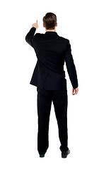 Image showing Rear view of a male model pointing