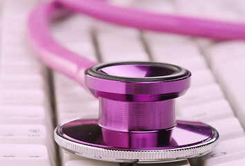 Image showing pink stethoscope on keyboard