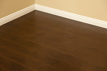 Image showing Newly Installed Brown Laminate Flooring and Baseboards in Home