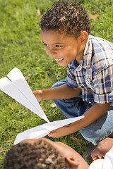 Image showing Mixed Race Father and Son Playing with Paper Airplanes