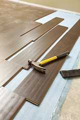 Image showing Hammer and Block with New Laminate Flooring