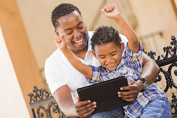 Image showing Mixed Race Father and Son Using Touch Pad Computer Tablet