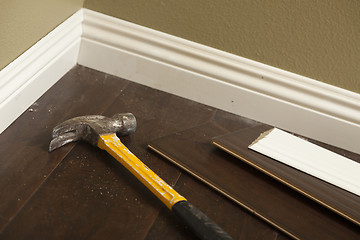 Image showing Hammer, Laminate Flooring and New Baseboard Molding