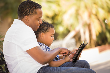 Image showing Mixed Race Father and Son Using Touch Pad Computer Tablet