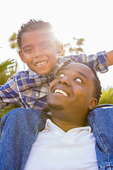 Image showing Mixed Race Father and Son Playing Piggyback