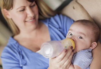 Image showing Happy Mother Bottle Feeding Her Son