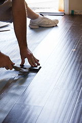 Image showing Man Installing New Laminate Wood Flooring