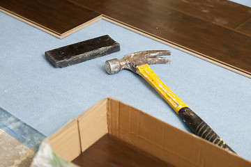 Image showing Hammer and Block with New Laminate Flooring