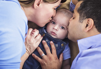 Image showing Mixed Race Parent Kissing Their Son
