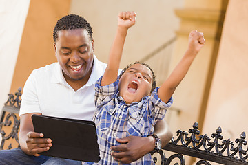 Image showing Mixed Race Father and Son Using Touch Pad Computer Tablet