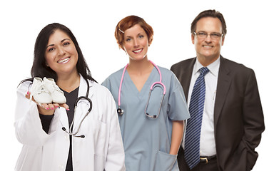 Image showing Hispanic Female Doctor or Nurse with Baby Shoes and Support Staf