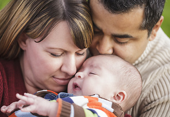 Image showing Happy Mixed Race Parents Hugging Their Son