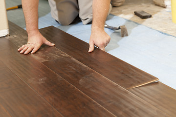 Image showing Man Installing New Laminate Wood Flooring