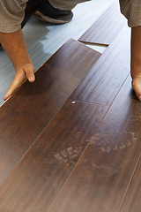 Image showing Man Installing New Laminate Wood Flooring