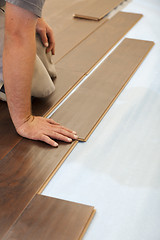 Image showing Man Installing New Laminate Wood Flooring