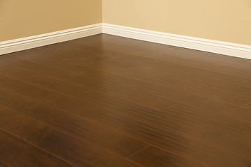 Image showing Newly Installed Brown Laminate Flooring and Baseboards in Home