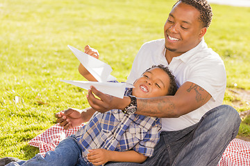 Image showing Mixed Race Father and Son Playing with Paper Airplanes