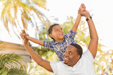 Image showing Mixed Race Father and Son Playing Piggyback