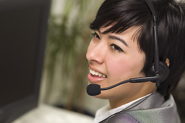 Image showing Attractive Young Mixed Race Woman Smiles Wearing Headset