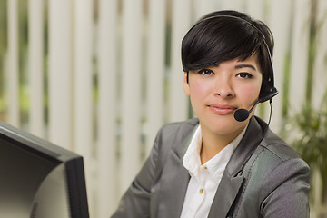 Image showing Attractive Young Mixed Race Woman Smiles Wearing Headset