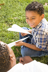 Image showing Mixed Race Father and Son Playing with Paper Airplanes