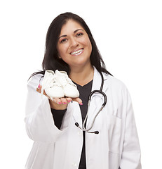 Image showing Hispanic Female Doctor or Nurse with Baby Shoes on White
