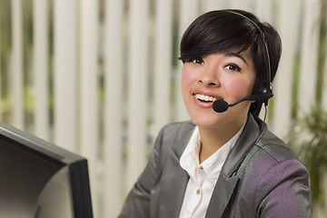 Image showing Attractive Young Mixed Race Woman Smiles Wearing Headset