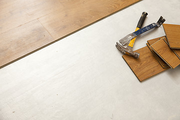 Image showing Hammer and Pry Bar with Laminate Flooring Abstract