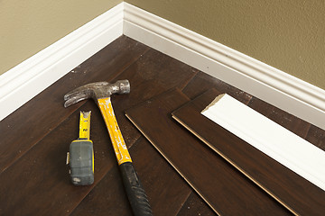 Image showing Hammer, Laminate Flooring and New Baseboard Molding