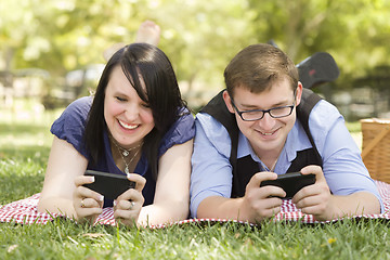 Image showing Young Couple at Park Texting Together