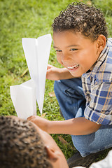 Image showing Mixed Race Father and Son Playing with Paper Airplanes