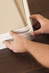 Image showing Contractor Installing New Baseboard with Bull Nose Corners and N