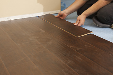 Image showing Man Installing New Laminate Wood Flooring