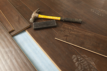 Image showing Hammer and Block with New Laminate Flooring