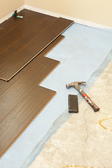 Image showing Hammer and Block with New Laminate Flooring