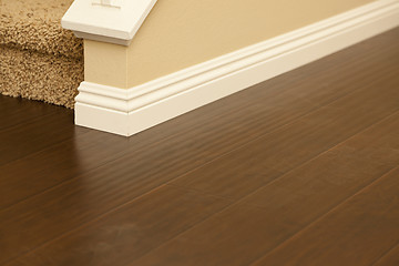 Image showing Newly Installed Brown Laminate Flooring and Baseboards in Home