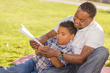 Image showing Mixed Race Father and Son Playing with Paper Airplanes