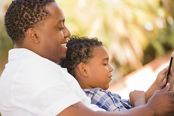 Image showing Mixed Race Father and Son Using Touch Pad Computer Tablet