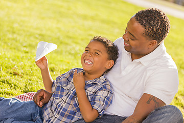 Image showing Mixed Race Father and Son Playing with Paper Airplanes