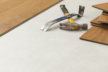 Image showing Hammer and Pry Bar with Laminate Flooring Abstract