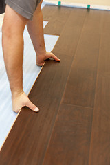 Image showing Man Installing New Laminate Wood Flooring