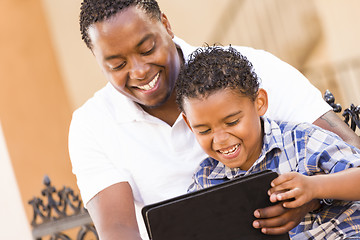 Image showing Mixed Race Father and Son Using Touch Pad Computer Tablet