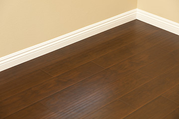 Image showing Newly Installed Brown Laminate Flooring and Baseboards in Home