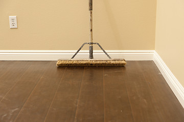 Image showing Push Broom on a Newly Installed Laminate Floor and Baseboard