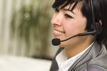 Image showing Attractive Young Mixed Race Woman Smiles Wearing Headset