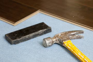 Image showing Hammer and Block with New Laminate Flooring