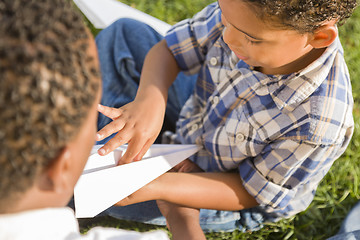 Image showing Mixed Race Father and Son Playing with Paper Airplanes