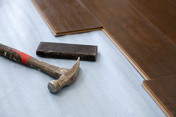 Image showing Hammer and Block with New Laminate Flooring